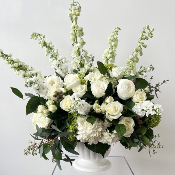Floral urn with premium flowers in white ceramic vase