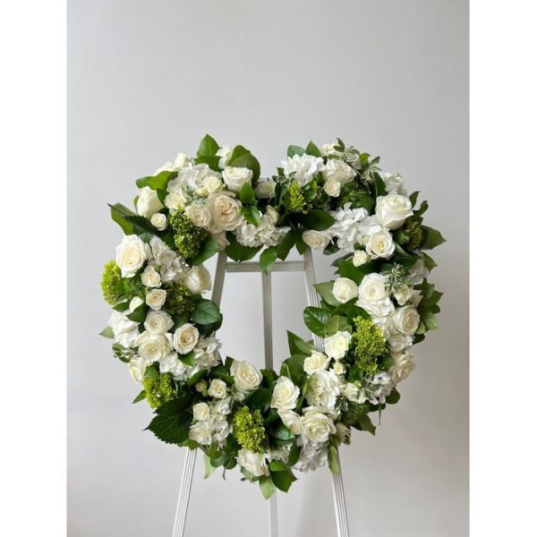 open floral funeral heart on white easel